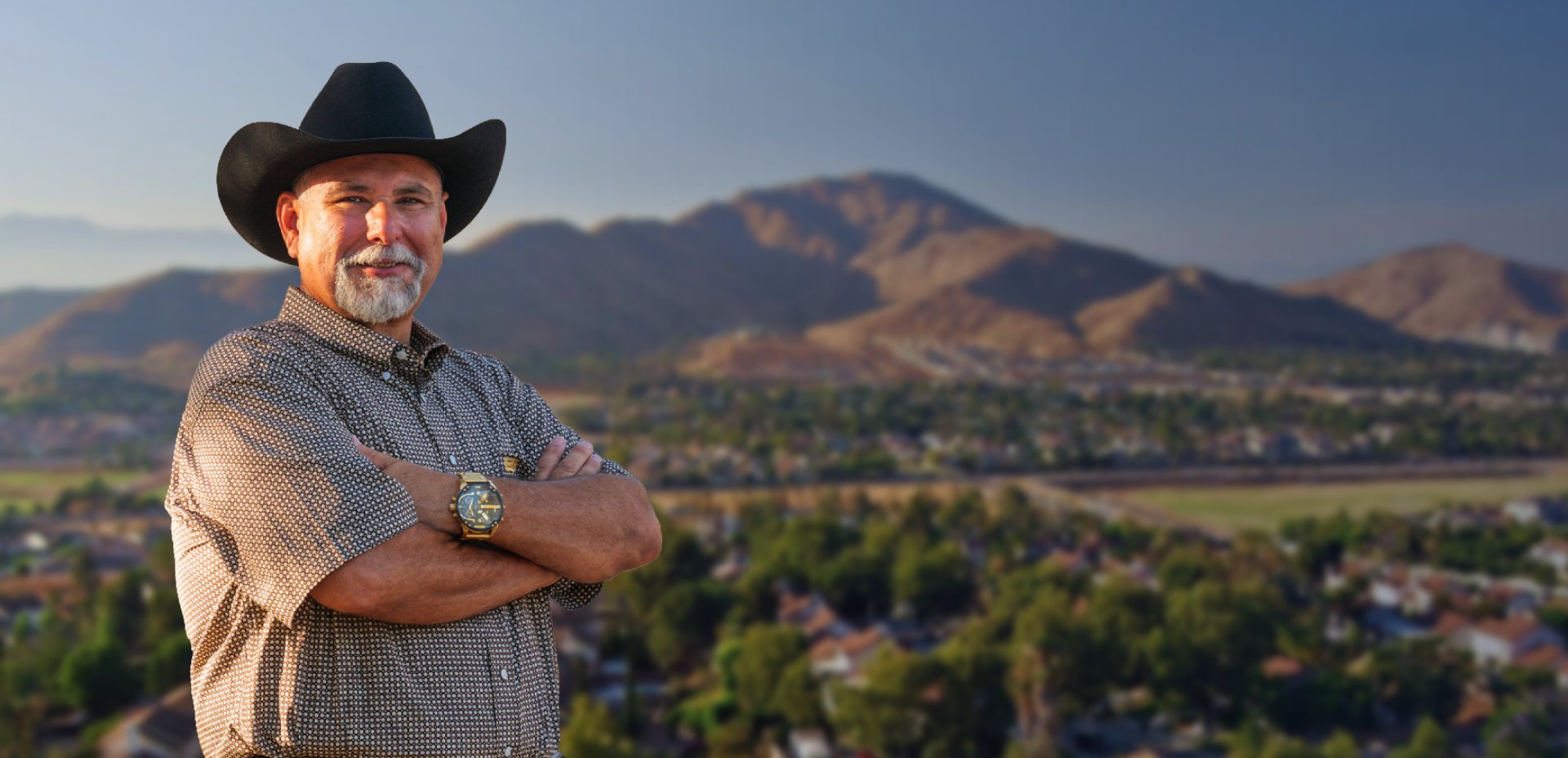 Chris Rosales in a black cowboy hat, arms crossed, overlooking Jurupa Valley